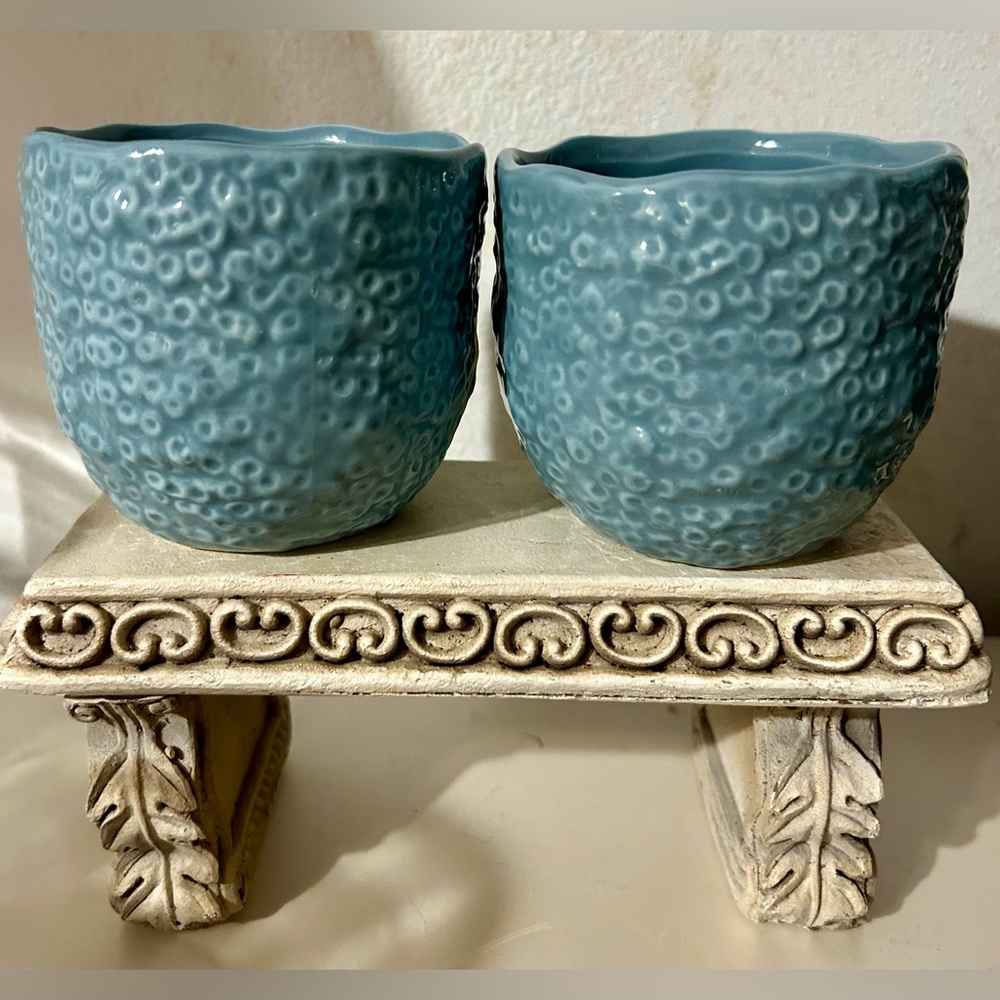 2 turquoise, textured ceramic tea cups.